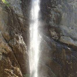 a large waterfall over a rock wall