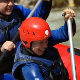 a young boy holding a baseball bat