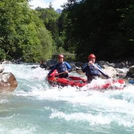 a group of people riding on a raft in a body of water
