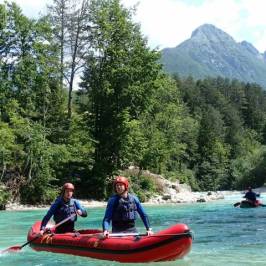 a group of people riding on the back of a boat in the water