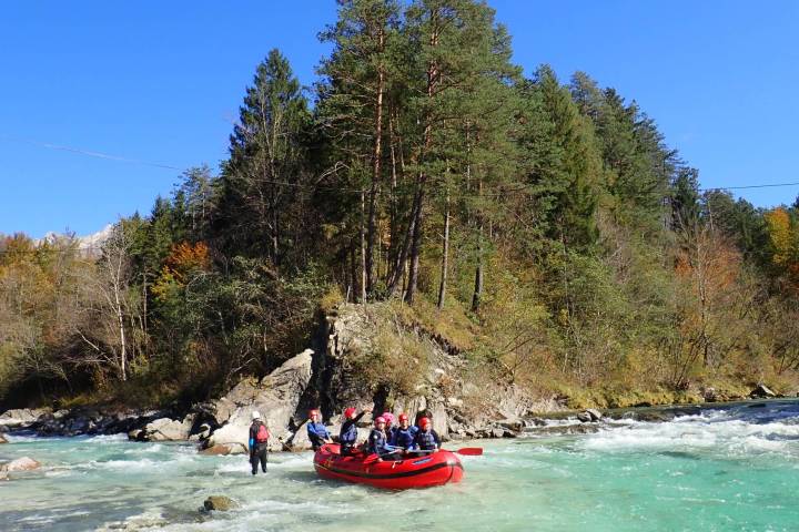 a group of people riding on the back of a boat in the water