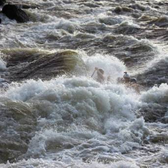 a man riding a wave on top of a body of water