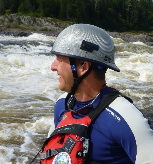 a man standing next to a body of water