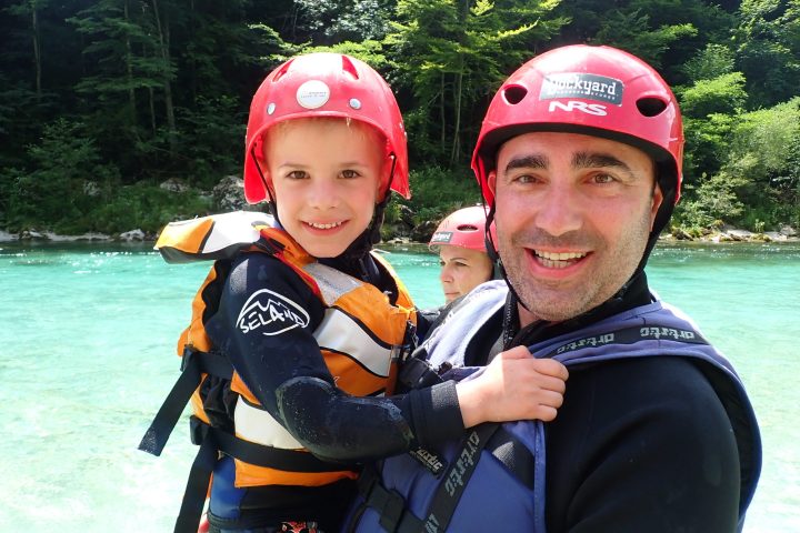 a boy wearing a hat and sunglasses posing for the camera