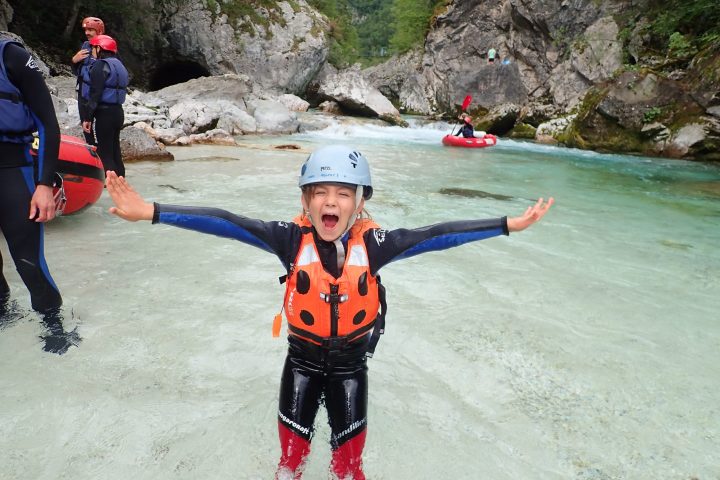 a little boy that is standing in the water