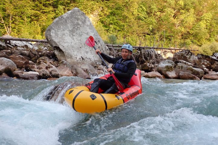 a man riding on a raft in a body of water