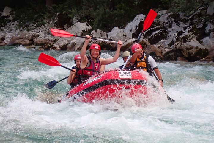 a group of people riding skis on a raft in the water