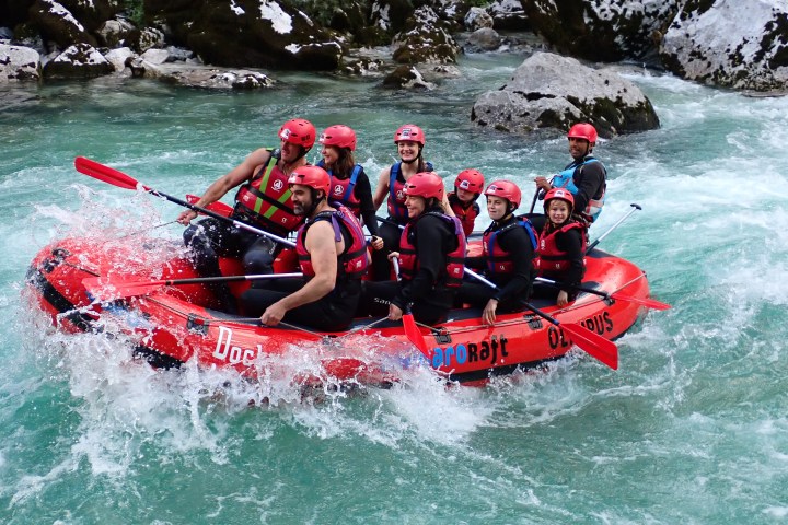 Whitewater rafting on the Soča River in Slovenia. HungaroRaft guests paddling through rapids.